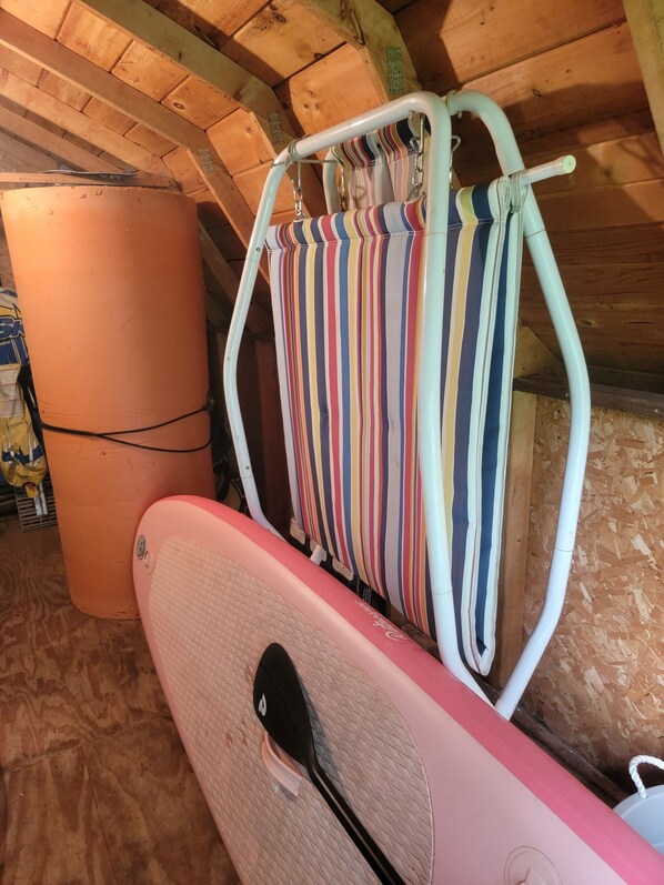 A rustic wooden ceiling with a hammock and a surfboard leaning against it. - Cozy 3-bedroom cabin in wonderful Perham with WiFi, AC and great fishing! (Perham)