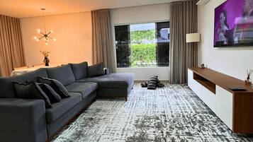 Villa | Living area | 55-inch flat-screen TV with digital channels, TV
