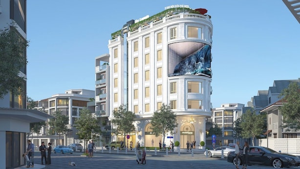 A modern hotel with a curved facade, large windows, and a prominent digital display.