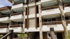 A multi-story hotel with a central atrium, balconies, and a pool area. - Cebu Westown Lagoon-Partywing (Mandaue)