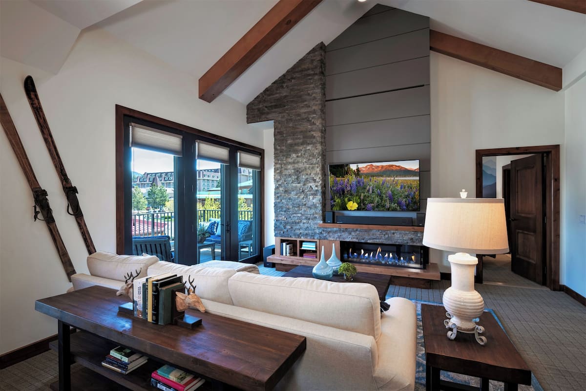 A living room with a fireplace, a television, and a sofa.