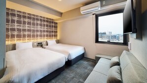 A hotel room with two beds, a sofa, a city view, and an air conditioning unit. - KOKO HOTEL Osaka Namba Sennichimae (Osaka)