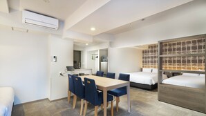 A hotel room with a dining area, a kitchenette, and two beds. - KOKO HOTEL Osaka Namba Sennichimae (Osaka)