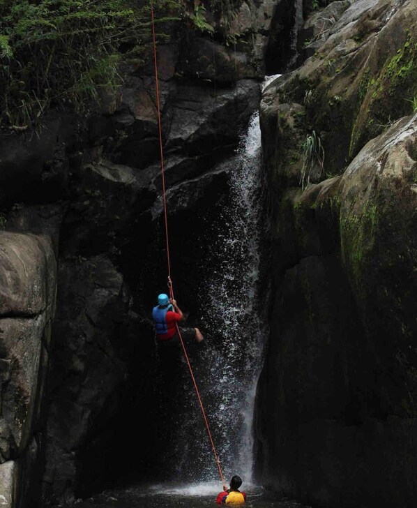 A person rappelling down a rocky waterfall. - Near Ferry to Culebra Solar-powered Cozy (Ceiba)