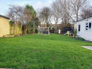 Enjoy an and serene atmosphere in this beautifully maintained backyard with a soccer goal.