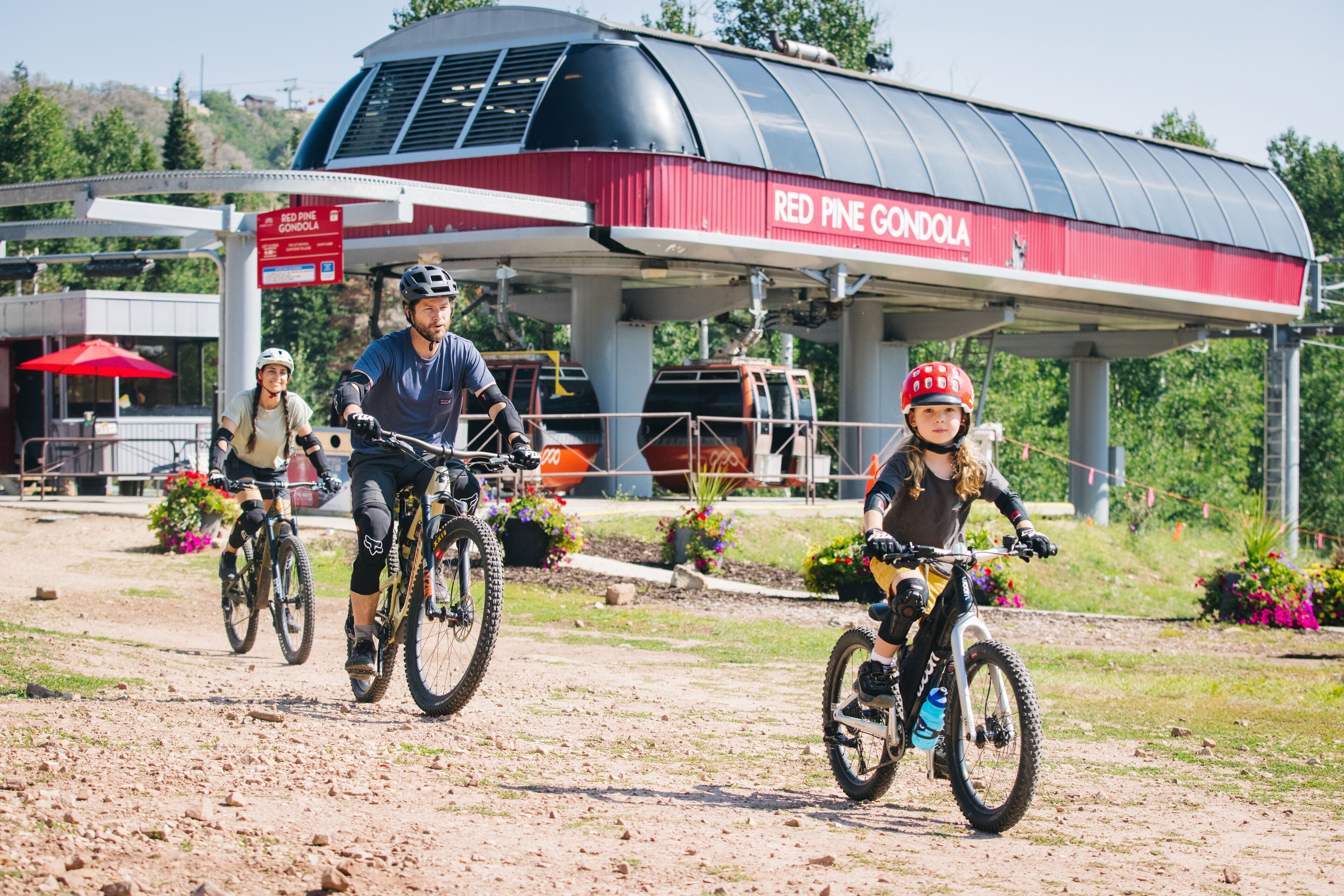 A mountain biking area with a covered shelter labeled "Red Pine Gondola".