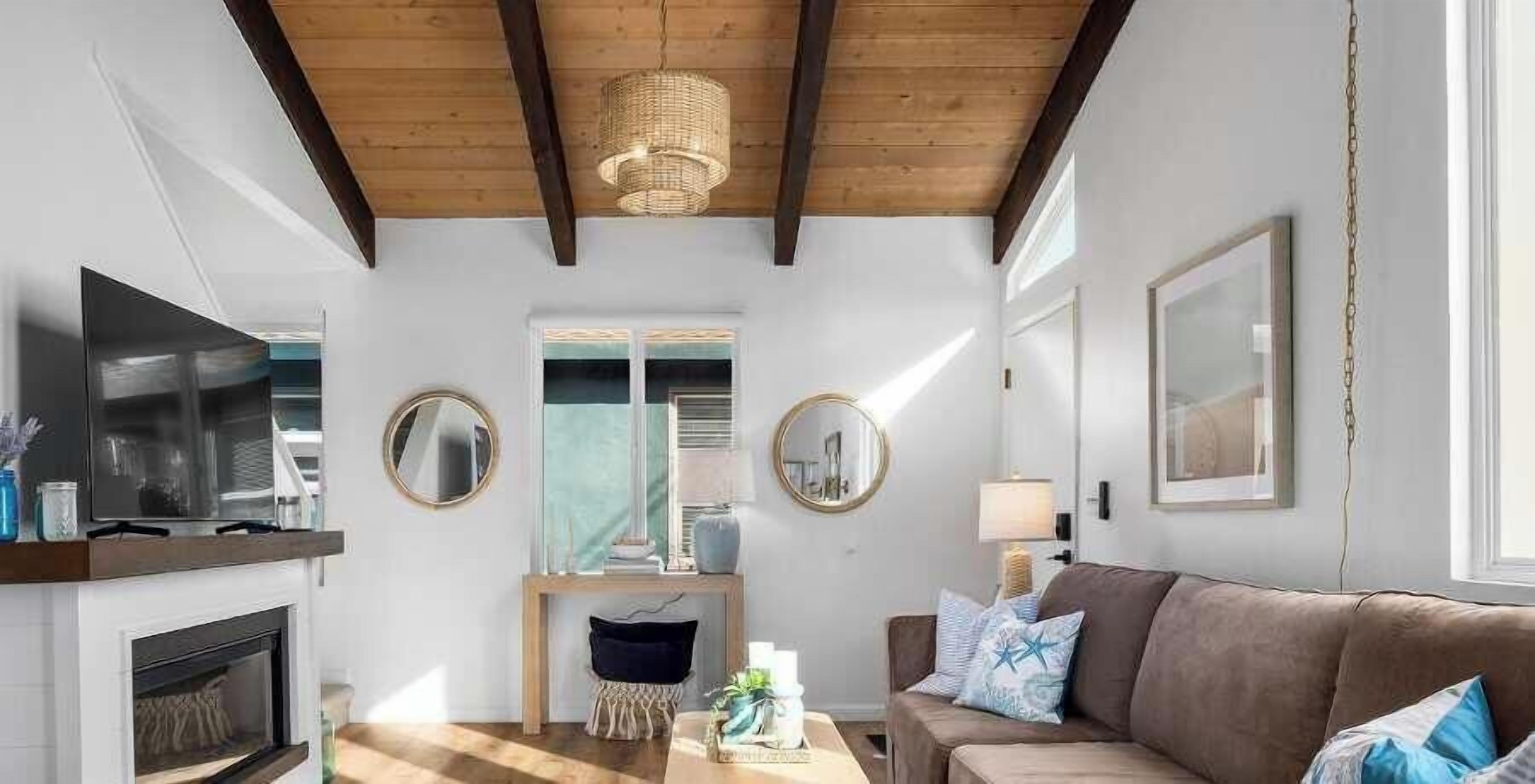 Una sala de estar con chimenea, un sofá, una mesa de centro y un televisor.