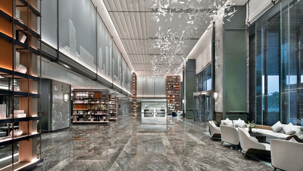 A spacious lobby with a high ceiling, marble flooring, and modern furniture. - THE MORDIN HOTEL (Guangzhou)