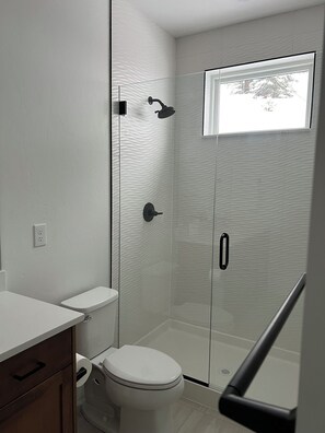 Shower, hair dryer, towels, toilet paper