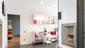 A modern kitchen with a central island, white chairs, and a built-in stove. - Bright and spacious one-bedroom apartment of almost 100 square meters located in Via Carlo d'Adda 5, in the heart of Milan, in an IN area full of life and with numerous connections via local transportation (P.ta Genova FS station and metro stop a few min (Milano)