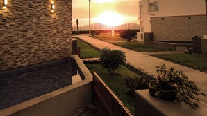 A modern building with a stone facade and a well-maintained garden area. - Between Mala and Asia Boulevard, Bujama Beach house in Moravia II! (Bujama, Asia)