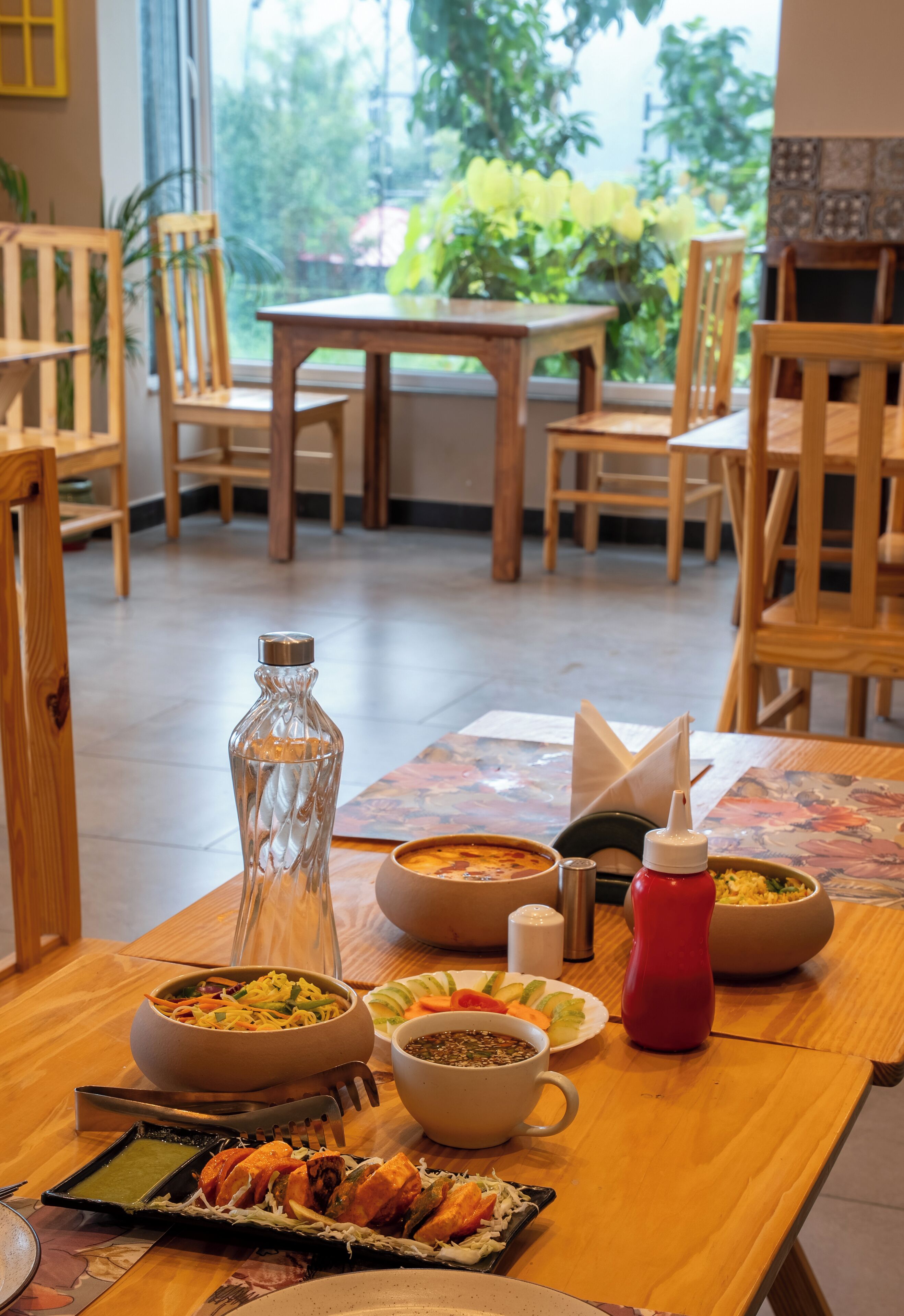A dining table with various dishes, a bottle, and condiments.