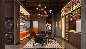 A modern bar area with a bar counter, seating, and a neon sign. - Merica Hotel -Chengdu Chunxi Road (Chengdu)