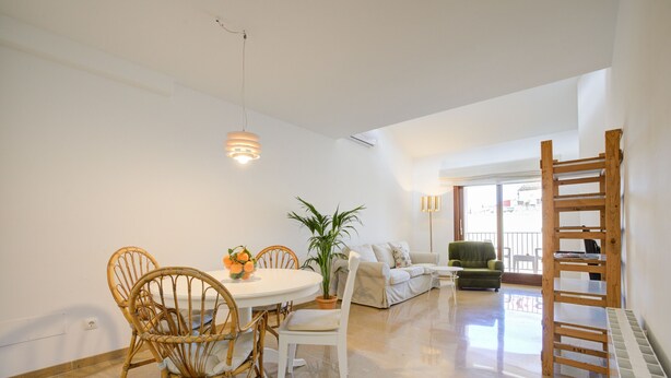A spacious living area with a dining table, chairs, a sofa, and a staircase. - Comtat Muro 2 by Rentallorca (Muro)