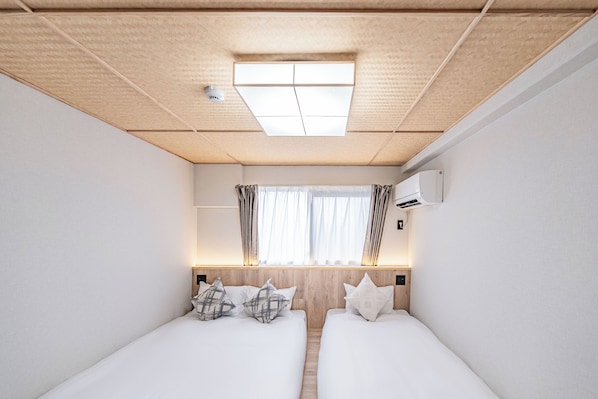 Chambre avec lits jumeaux, plusieurs lits, non-fumeurs | Rideaux occultants, Wi-Fi gratuit
