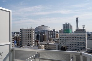 Panorama urbano con un edificio a cupola ben visibile, grattacieli e una torre con antenne.