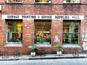 GRANGE PRINTING & OFFICE SUPPLIES PTY. LTD. offers a charming urban storefront with large windows and a welcoming entrance.
