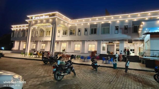 A hotel with a modern design, featuring a covered outdoor seating area and multiple rooms. - Hotel Vrindavan (Unnao)