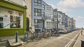 A row of modern townhouses with a bike parking area in front. - Host Stay St James Street (Brighton)