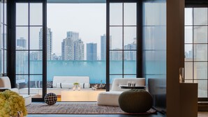 A modern living room with a city view, a sofa set, a coffee table, and a decorative vase. - INDITION Chongqing Jiangbeizui Financial (Chongqing)
