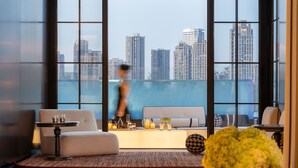 A modern hotel room with a large window offering a city view. - INDITION Chongqing Jiangbeizui Financial (Chongqing)