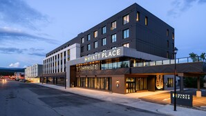 A modern Hyatt Place hotel with a prominent entrance, large windows, and a well-lit facade. - Hyatt Place Whitehorse (WHITEHORSE)