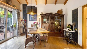 A dining area with a wooden table, chairs, and a cabinet.