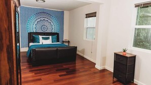 A bedroom with a bed, a nightstand, a dresser, and a window. - Cozy Retreat Near Fort Meade | Fire Pit (Severn)