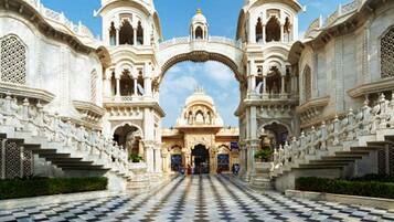 A grand entrance with intricate architecture, a checkered floor, and a central dome.