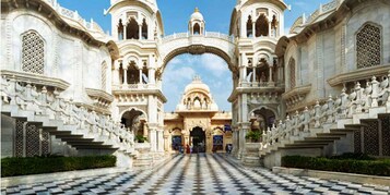 A grand entrance with intricate architecture, a checkered floor, and a central dome.