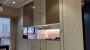 A modern kitchen with built-in cabinets and a countertop. - Southside by Daily Stays (Mumbai)