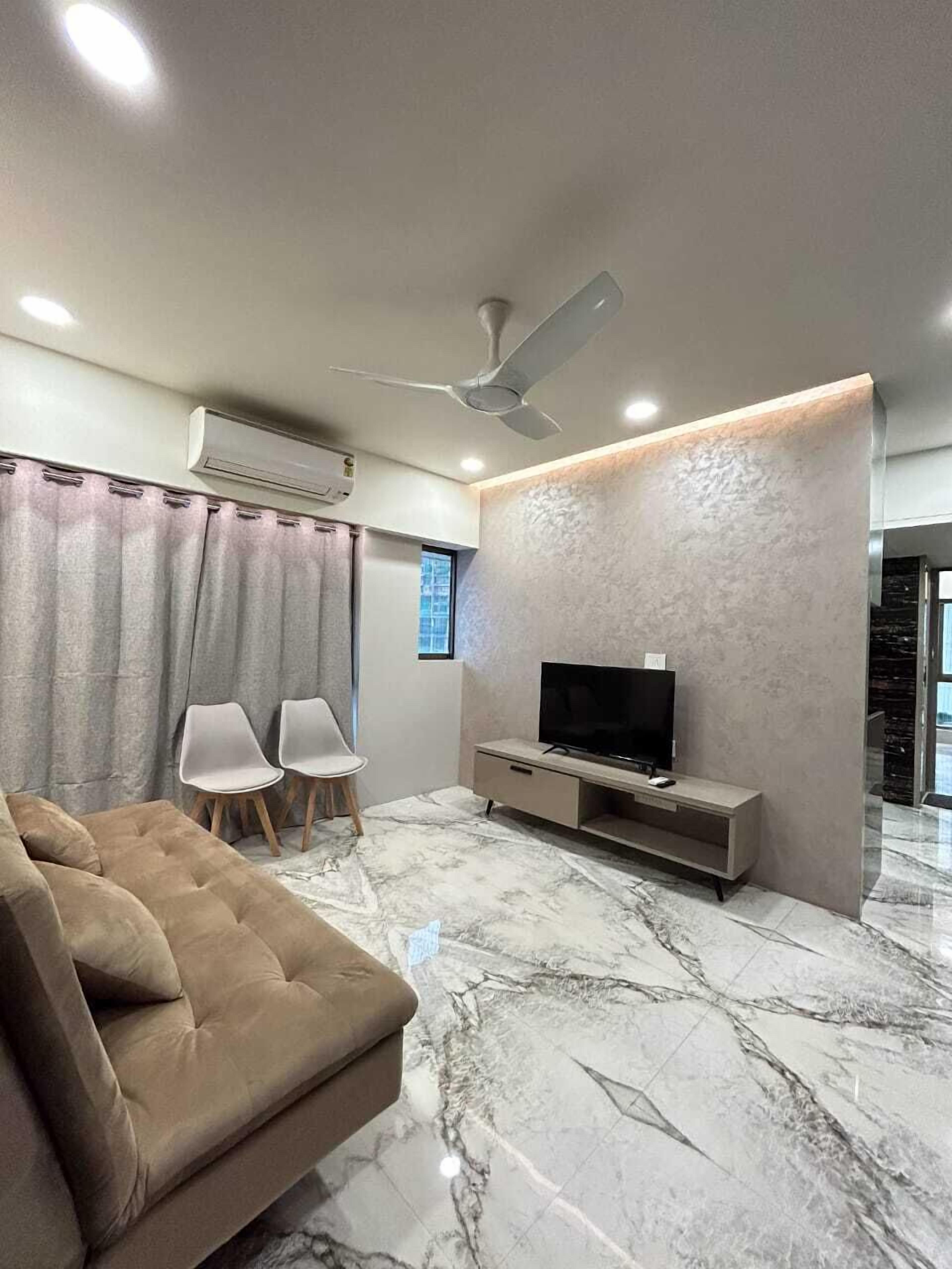 Downtown 1 BHK Apartment at Mahalaxmi, 601 | Living area | 45-inch Smart TV with digital channels