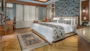 A modern hotel room with a large bed, a desk, and a chair. - Fortune Pahalgam  (Anantnag)