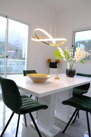 Enjoy meals in this stylish dining area with a large window offering a mountain view.