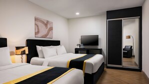 A hotel room with two beds, a flat-screen TV, a coffee maker, and a sliding door closet. - BRYQs Hotel Kuala Lumpur (Kuala Lumpur)