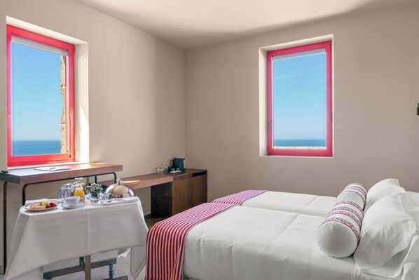 A hotel room with two beds, a desk with breakfast, and windows with a view. - HOTEL BOUTIQUE FARO SILLEIRO (Baiona)