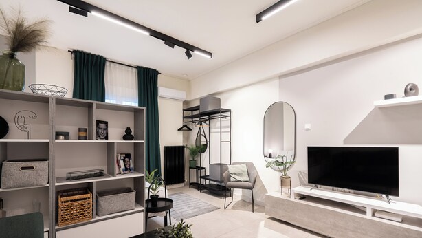 A modern living room with a flat-screen TV, a sofa, a coffee table, and a bookshelf. - Modern Studio, Walking distance to Kolonaki & The Ilisian (Athens)