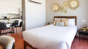 Une chambre à coucher avec un grand lit, une table de chevet et une chaise.