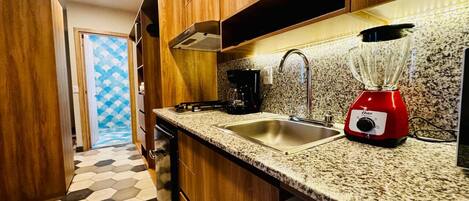 Microwave, coffee/tea maker, cookware/dishes/utensils, dining tables