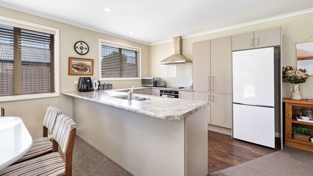 A kitchen with a central island, a microwave, a stove, and a refrigerator. - Perfect Cromwell Family Getaway! (Cromwell)