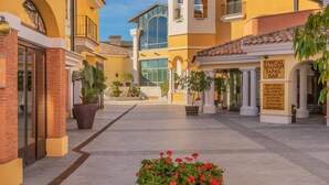 A courtyard with a bar, potted plants, and a sign indicating a typical Spanish tapas bar. - Comfortable 2 bed apartment - La Torre Golf AA1911 (Murcia)