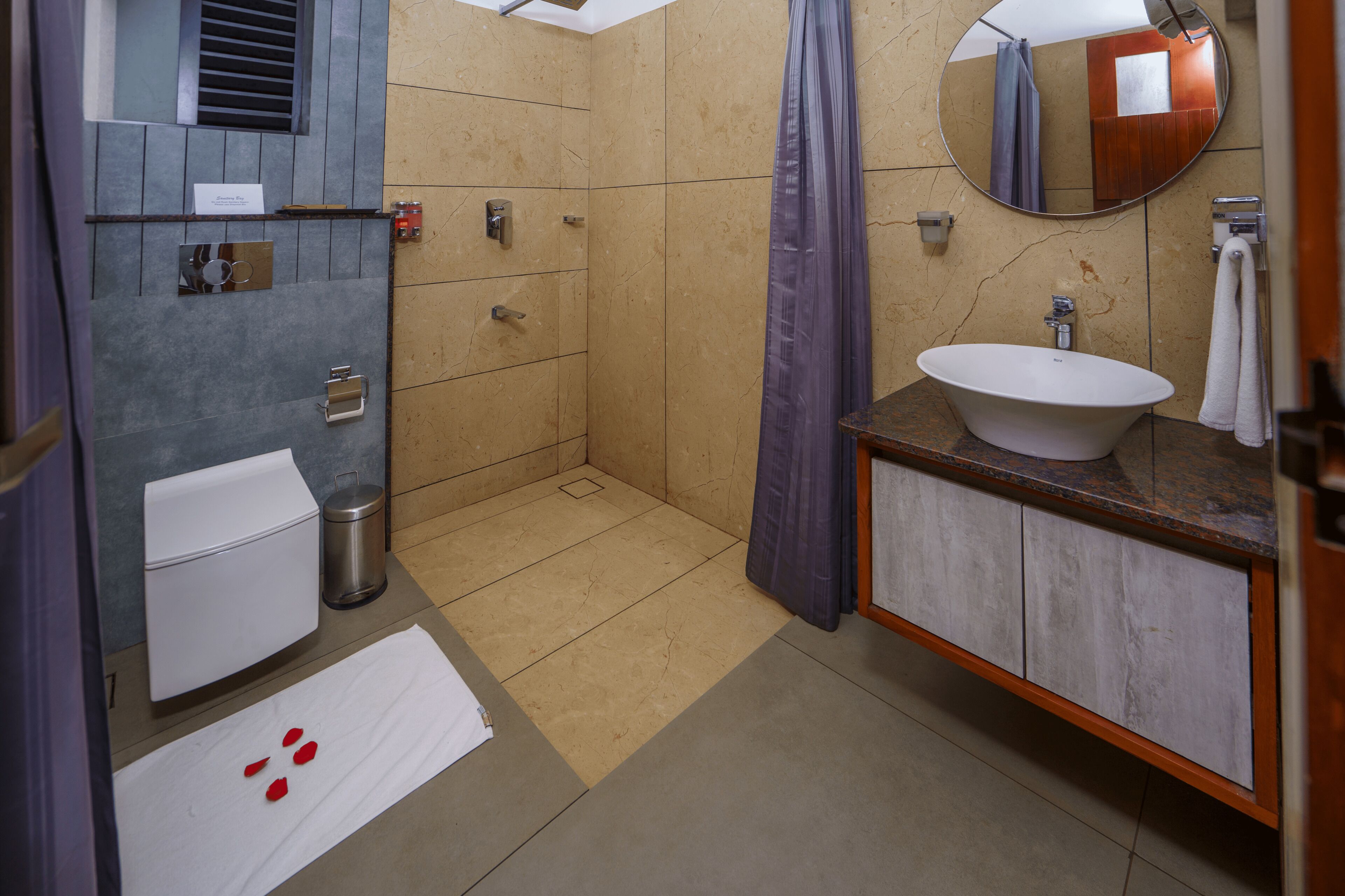 A bathroom with a bathtub, a sink, a toilet, a shower, and a mirror.