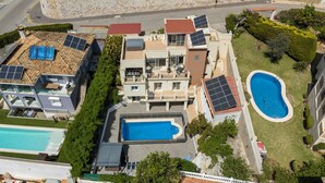 A residential property with a swimming pool, solar panels, and a well-maintained garden. - 6 bedroom villa with sea views (Mijas)