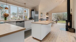 A modern kitchen with a central island, large windows, and a wood-paneled ceiling. - Beautiful home in Fårevejle with WiFi (Fårevejle)