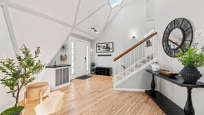 A spacious loft with a high ceiling, wooden flooring, a staircase, and a view of the sky. - Dome Manor / Pool + Hot Tub + Two Game Rooms (Bedford)