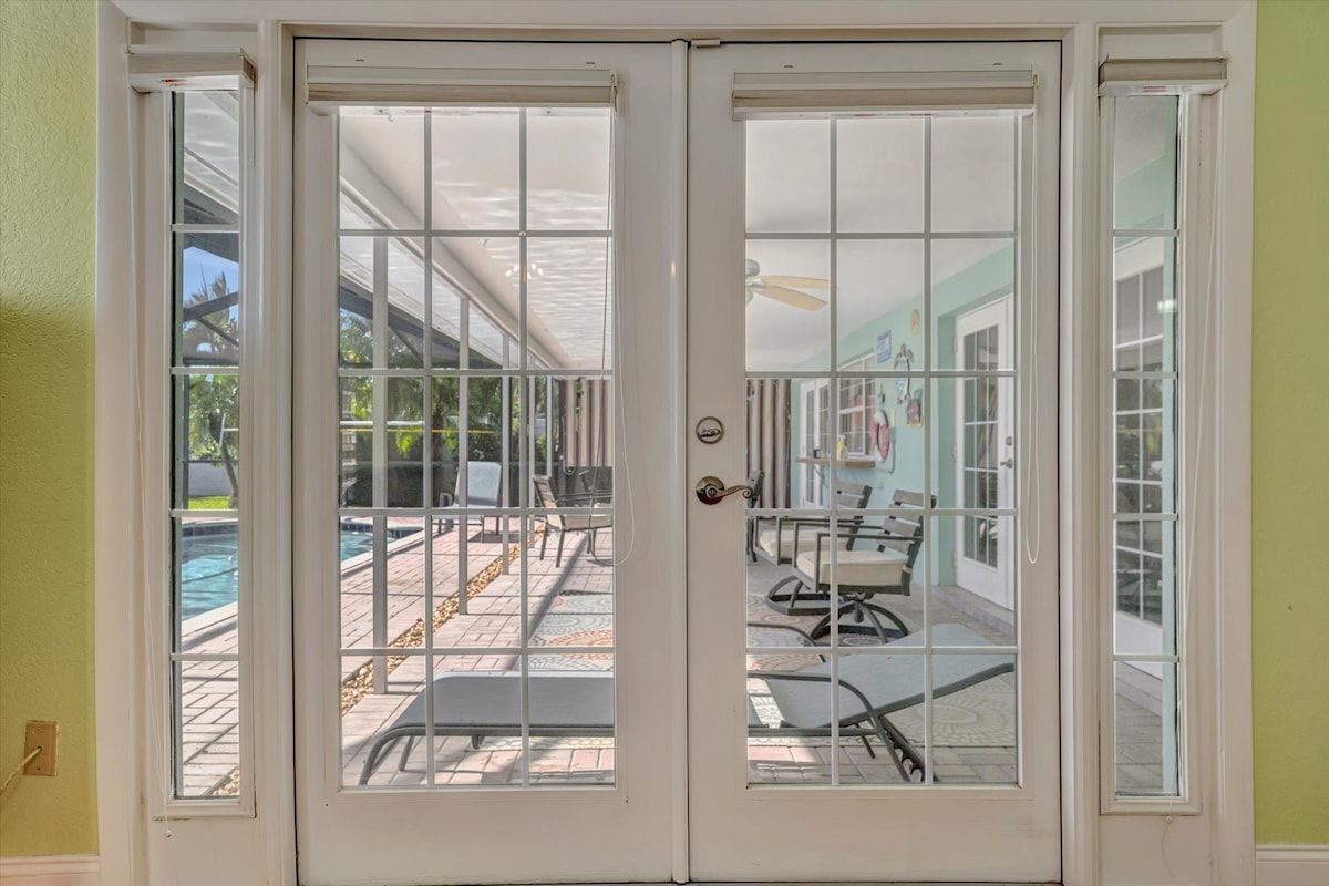 French doors open to your private patio, where sunlit seating invites you to relax beside the sparkling pool and soak up the warm Florida sunshine.