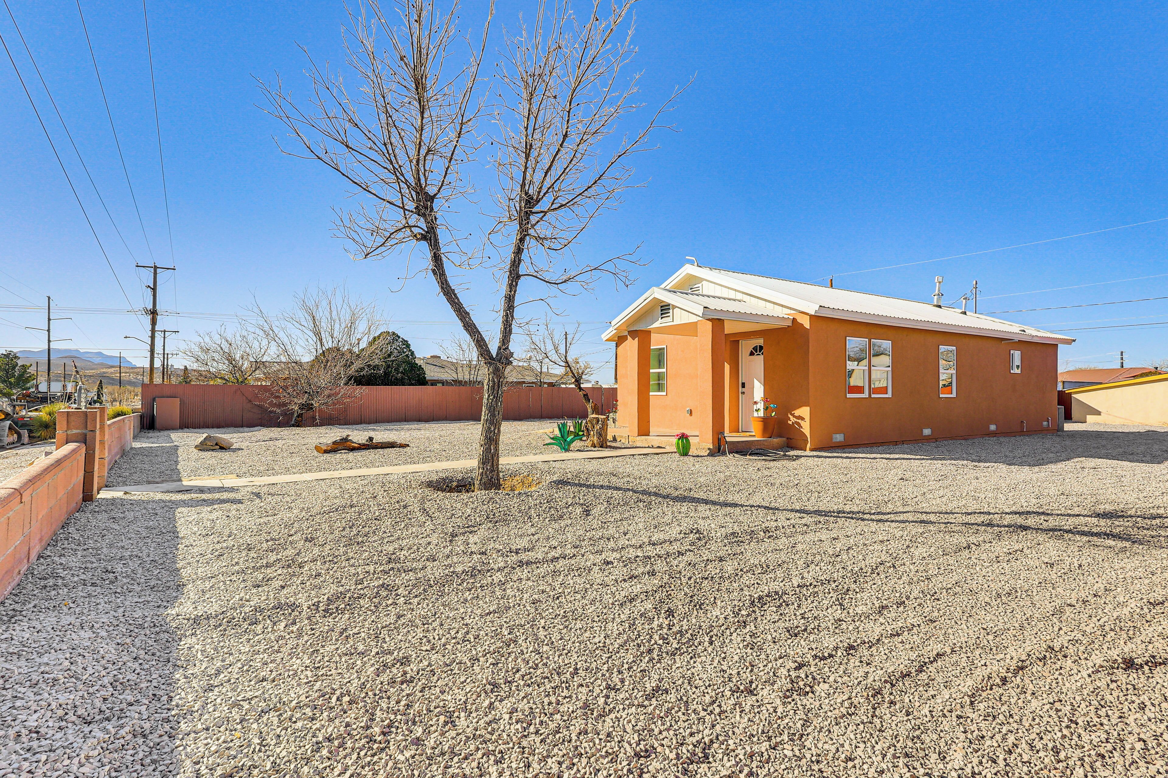 A small, single-story building with a flat roof and a gravel driveway.