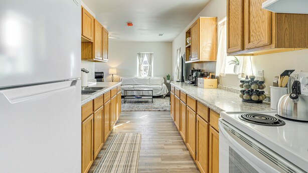 A modern kitchen with wooden cabinets, a built-in stove, and a countertop with kitchen appliances. - 3 Mi to Elephant Butte Lake: Cozy Retreat! (Truth or Consequences)