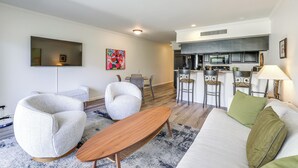 A modern living room with a sofa, two armchairs, a coffee table, and a dining area with a table and chairs. - Mtn-view Condo w/ Pool Access in Palm Springs! (Palm Springs)