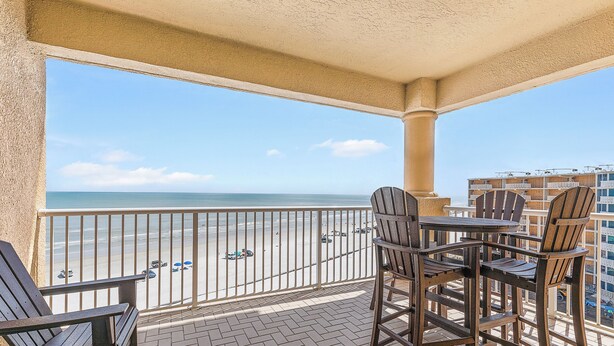 A balcony with a view of the beach, outdoor furniture, and a railing. - ☀️Oceanfront-Pool+Hot Tub-3BR-Atlantic Villas 601☀️ (New Smyrna Beach)